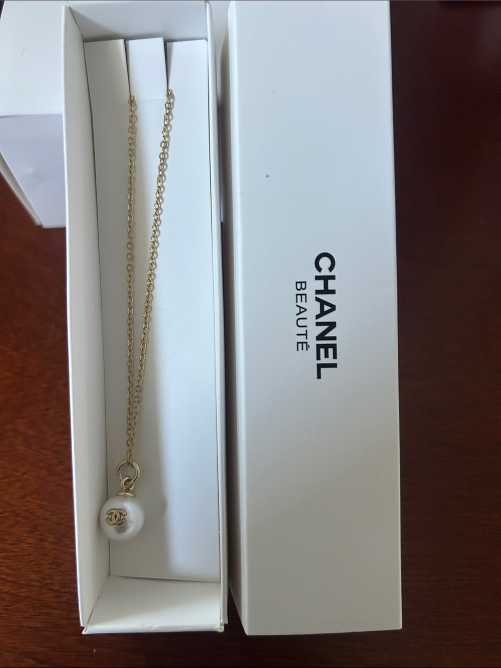 CHANEL Gold-Tone Chain with White Pearl CC Charm Necklace